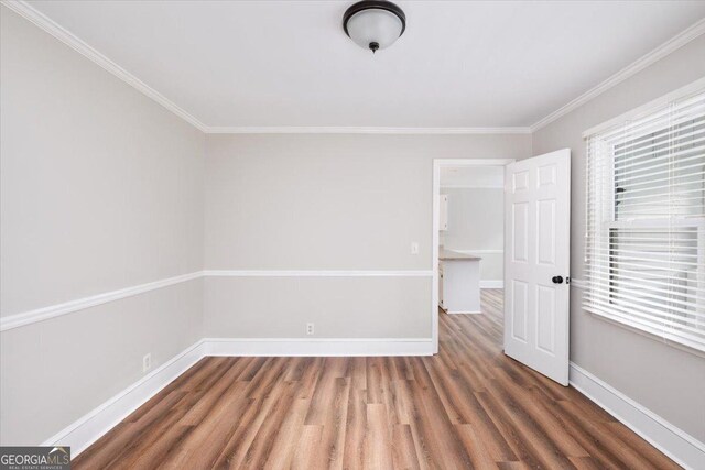 hall with dark hardwood / wood-style floors and crown molding