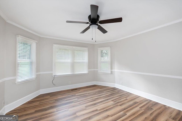 unfurnished room featuring hardwood / wood-style flooring, crown molding, and ceiling fan