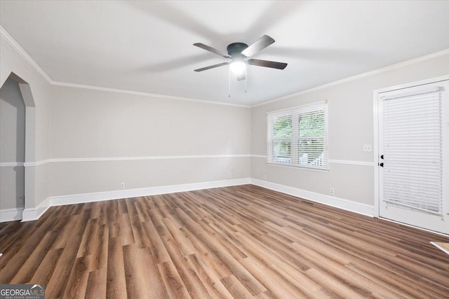 empty room featuring hardwood / wood-style flooring, crown molding, and ceiling fan