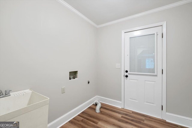 washroom featuring sink, hardwood / wood-style flooring, washer hookup, ornamental molding, and electric dryer hookup