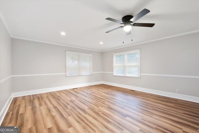 empty room featuring ceiling fan, light hardwood / wood-style flooring, and ornamental molding