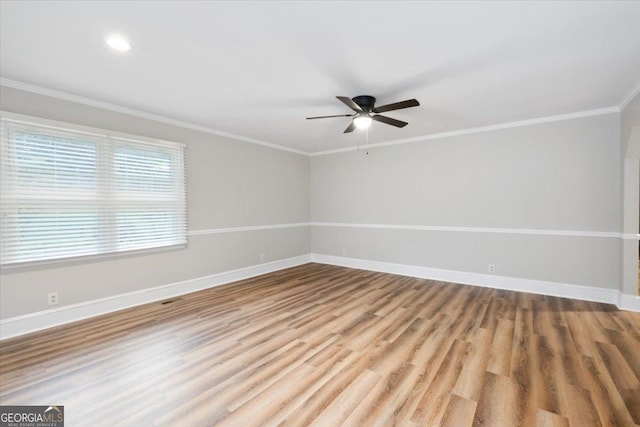 unfurnished room featuring ceiling fan, light wood-type flooring, and crown molding