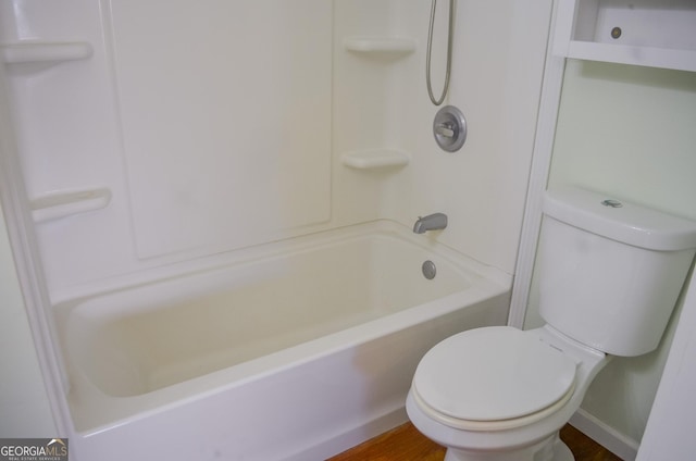 bathroom featuring toilet, tub / shower combination, and hardwood / wood-style flooring