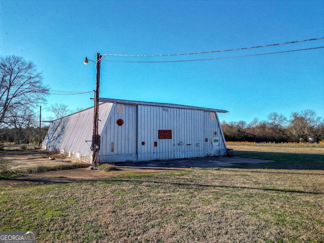 view of outdoor structure with a lawn