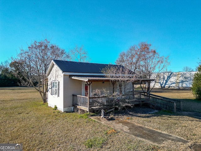 view of property exterior featuring a yard and a porch