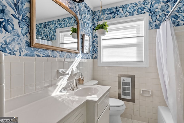 full bathroom featuring shower / bathtub combination with curtain, vanity, tile walls, toilet, and crown molding