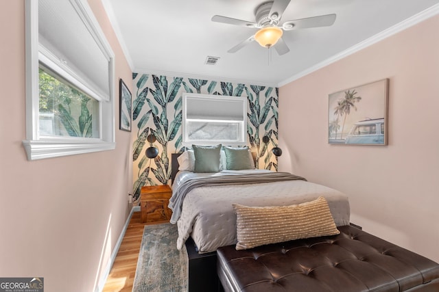 bedroom with ceiling fan, hardwood / wood-style flooring, and ornamental molding