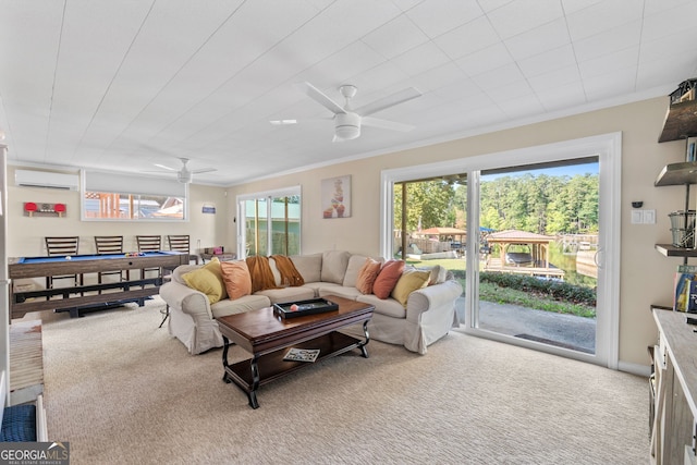 carpeted living room featuring a wall unit AC, ceiling fan, and crown molding