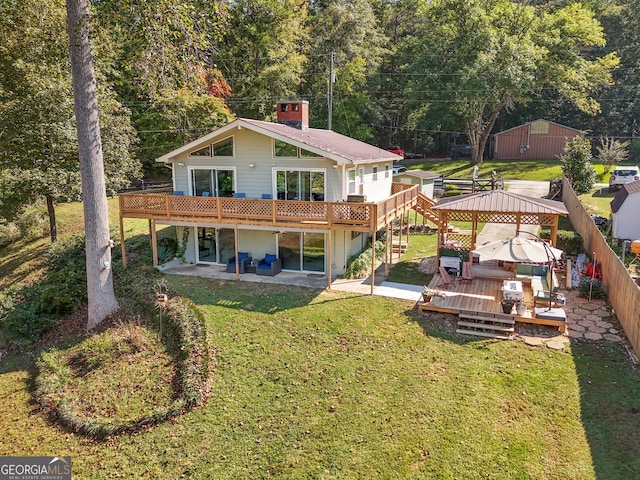 back of house with a lawn, a gazebo, a patio area, and a wooden deck