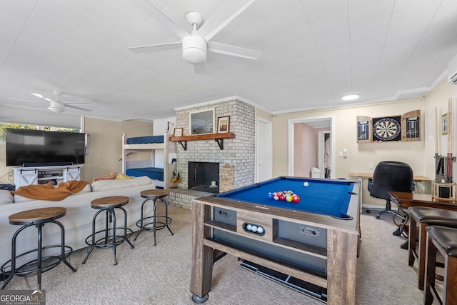 playroom with ceiling fan, billiards, a brick fireplace, ornamental molding, and light carpet