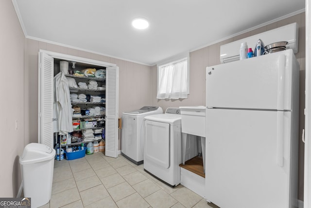 laundry room featuring washer and dryer, light tile patterned flooring, and ornamental molding