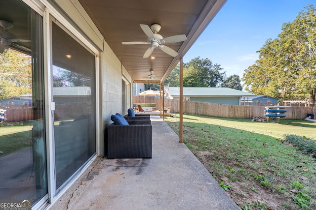 view of yard with ceiling fan, an outdoor living space, and a patio