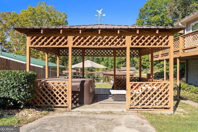 surrounding community featuring a wooden deck, a gazebo, and a hot tub