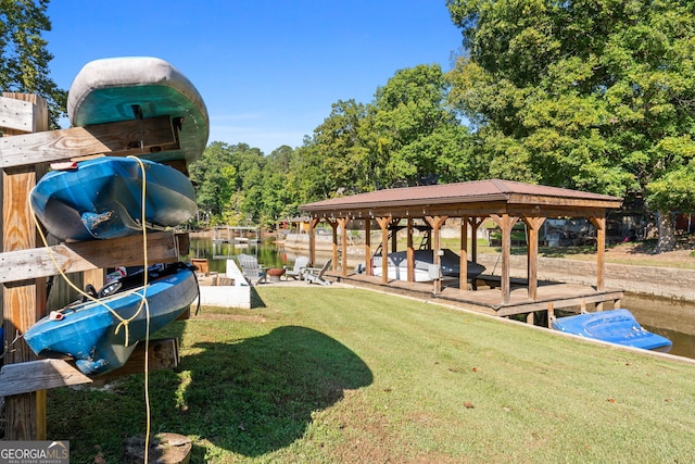 dock area featuring a lawn and a water view