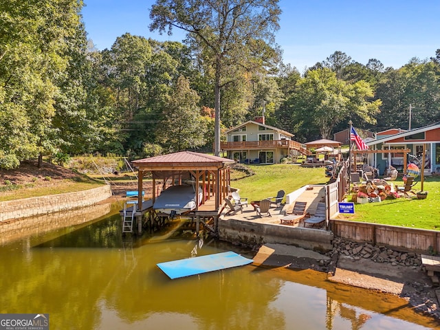 dock area featuring a water view and a yard