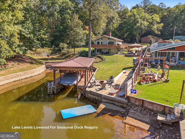 dock area with a yard and a water view