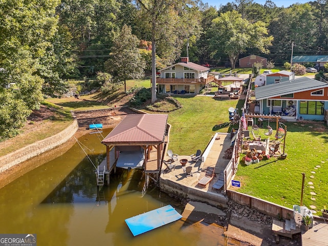 view of dock with a water view and a yard