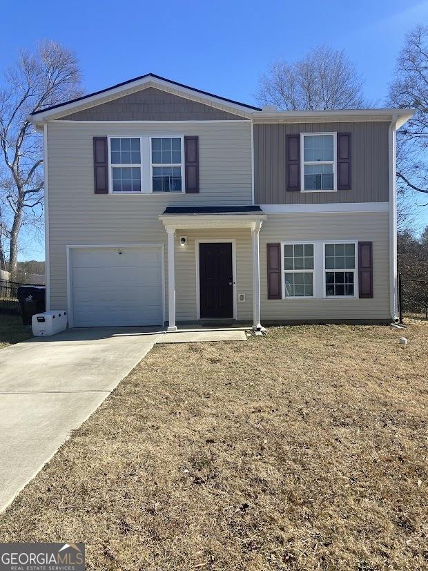 traditional-style home with concrete driveway and an attached garage