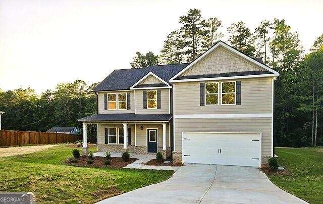 craftsman-style house with a front yard and a garage