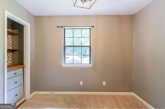 spare room with light colored carpet