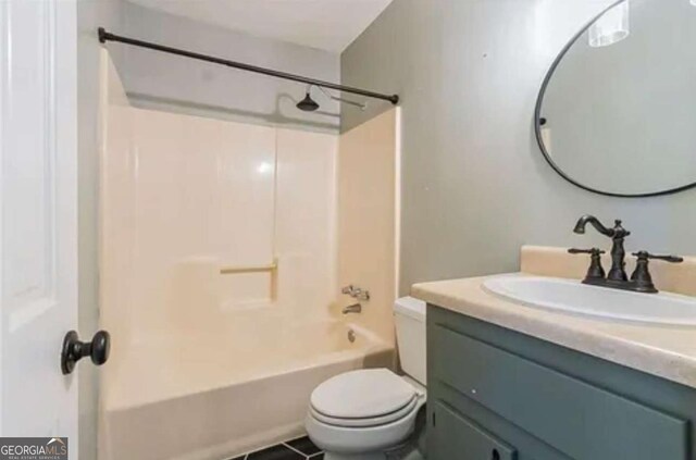 full bathroom with washtub / shower combination, vanity, toilet, and tile patterned flooring