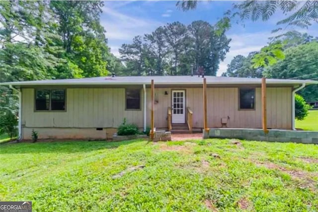 back of house with a lawn