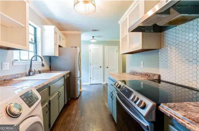 kitchen with white cabinets, washer / dryer, appliances with stainless steel finishes, sink, and range hood