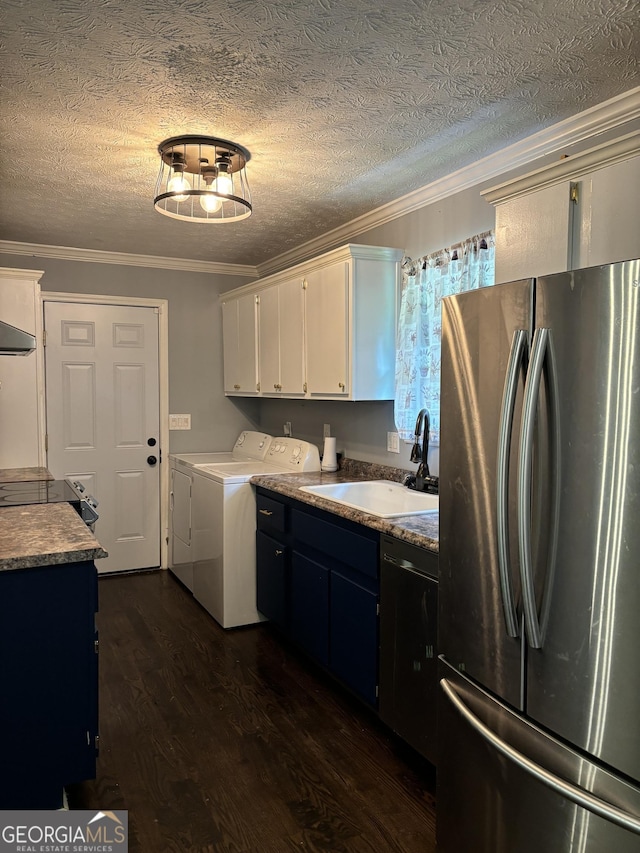 kitchen with stainless steel fridge, sink, white cabinetry, separate washer and dryer, and ornamental molding