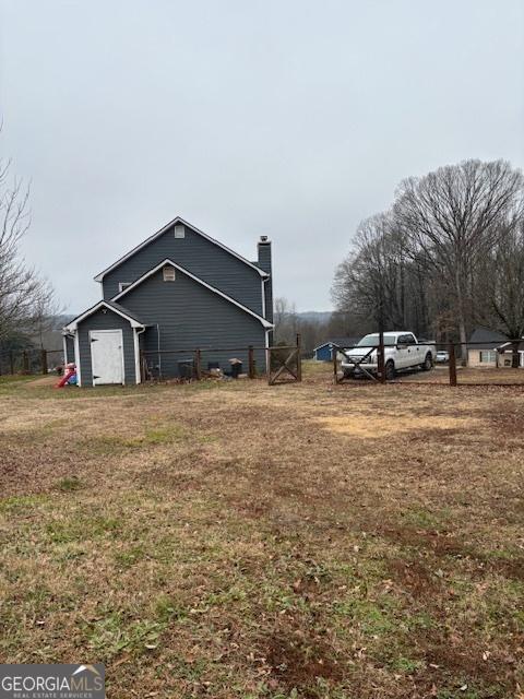 view of side of property featuring a yard