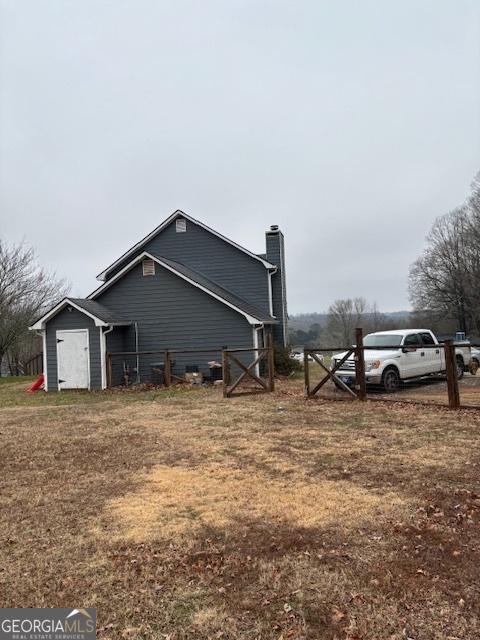 view of property exterior with a storage unit