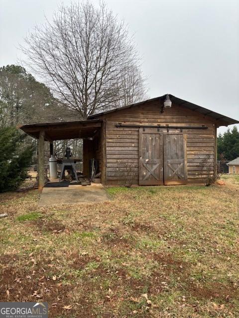 view of outbuilding with a lawn