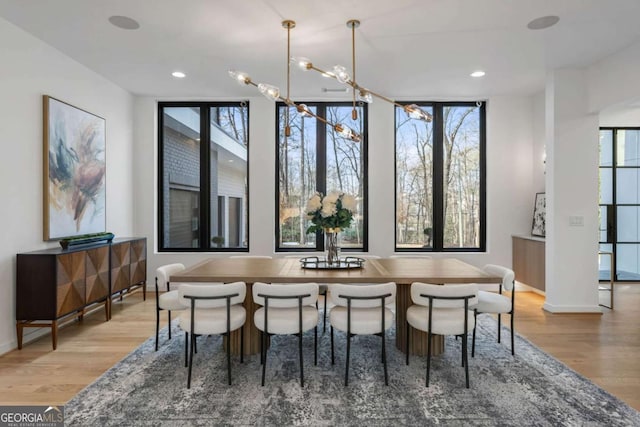 dining room featuring light hardwood / wood-style flooring and an inviting chandelier