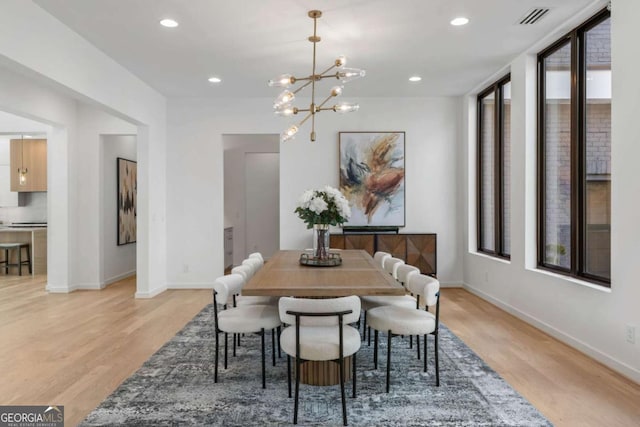 dining room featuring a chandelier and light wood-type flooring