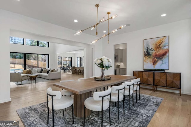 dining area with an inviting chandelier and wood-type flooring