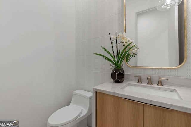 bathroom with toilet and vanity