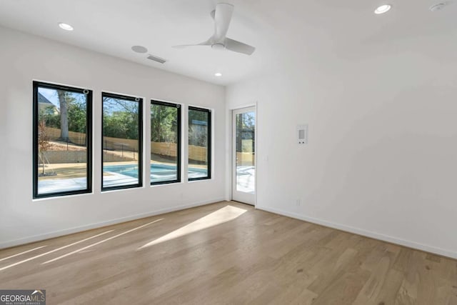 spare room featuring ceiling fan and light hardwood / wood-style floors