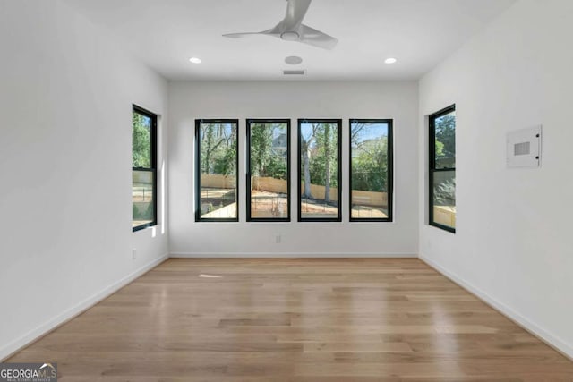 spare room with light wood-type flooring and ceiling fan