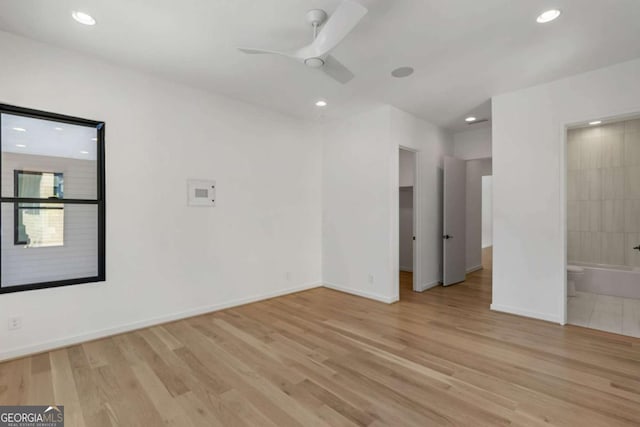 empty room with ceiling fan and light wood-type flooring