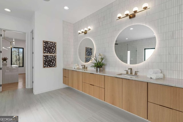 bathroom with backsplash, tile walls, walk in shower, and vanity