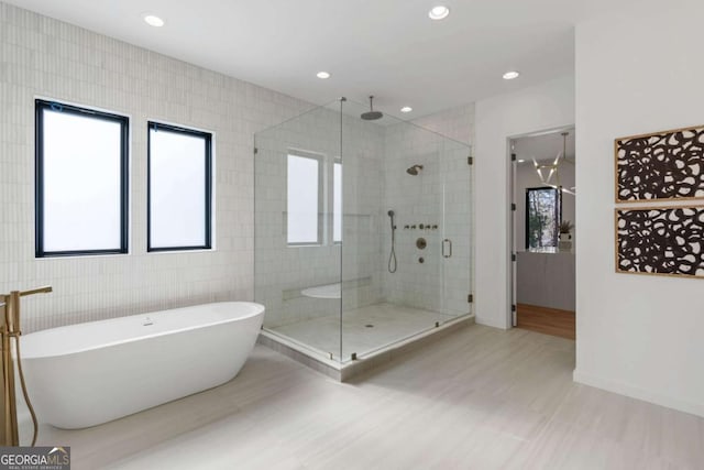 bathroom featuring tile walls and plus walk in shower