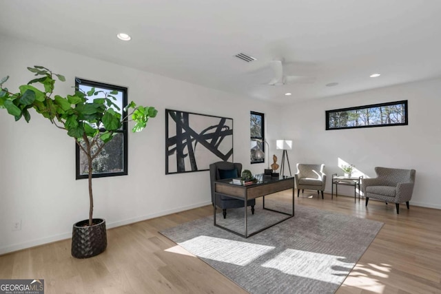 office space featuring ceiling fan and light hardwood / wood-style flooring