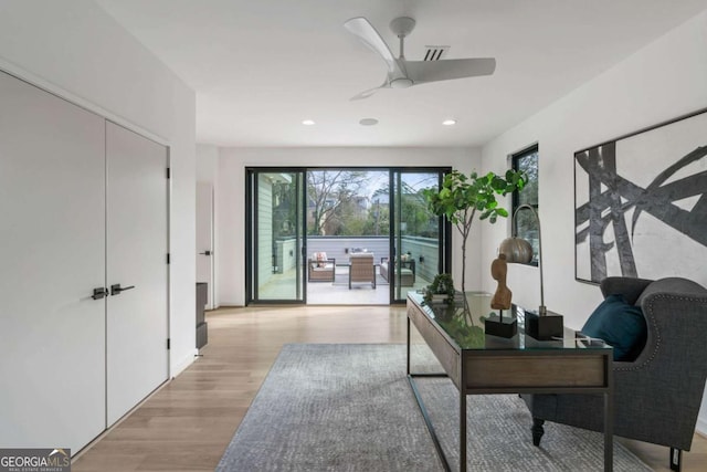 office area with ceiling fan and light hardwood / wood-style flooring