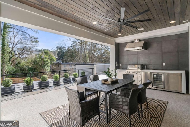 view of patio featuring ceiling fan, wine cooler, exterior kitchen, and a grill