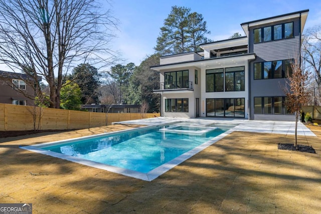 view of pool with a diving board, an in ground hot tub, and a patio