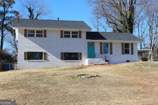 split level home featuring a front yard and a carport