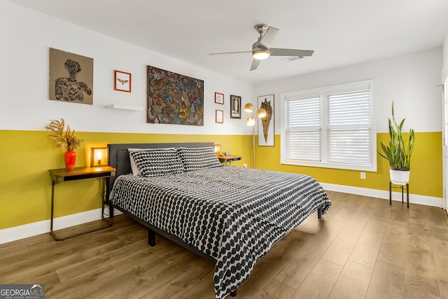 bedroom with hardwood / wood-style flooring and ceiling fan