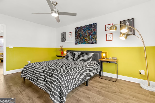 bedroom with hardwood / wood-style floors and ceiling fan