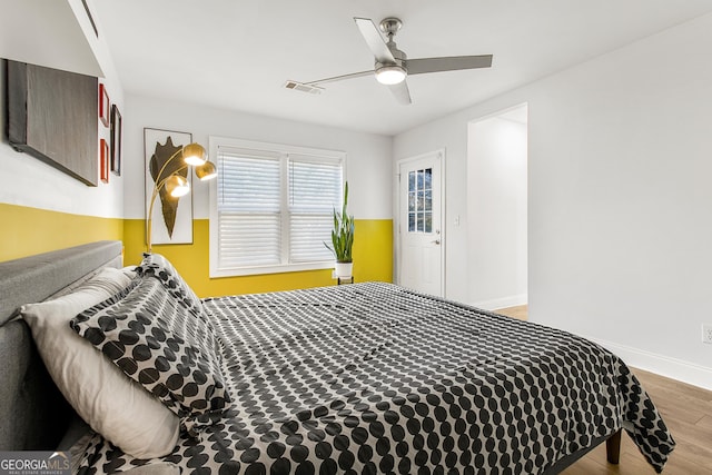 bedroom with wood-type flooring and ceiling fan