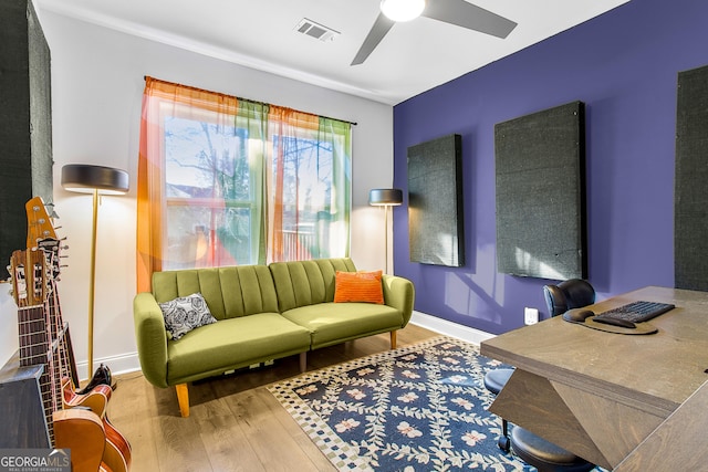 sitting room with hardwood / wood-style flooring and ceiling fan