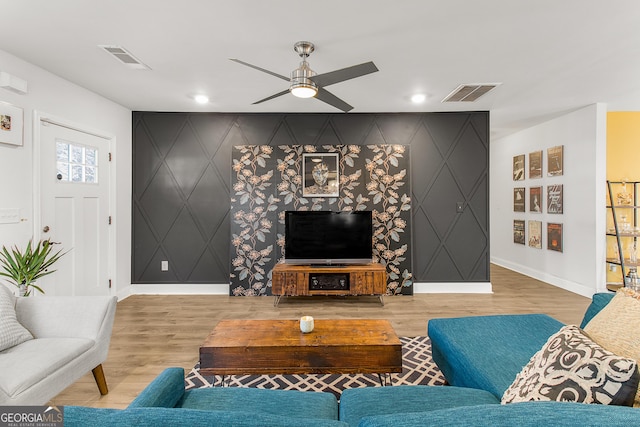 living room with hardwood / wood-style flooring and ceiling fan